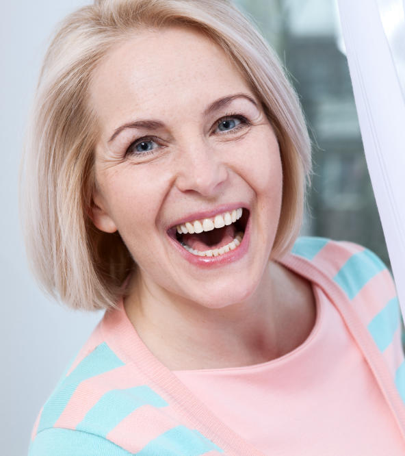 Happy mature woman showing perfect teeth in her smile.